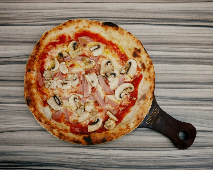 A pizza sitting on top of a wooden table